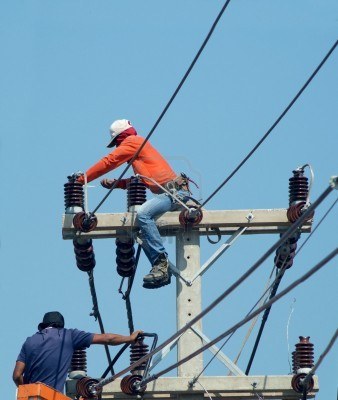 2276381-silhouette-men-performing-maintenance-work-on-a-pole-for-electric-wiring